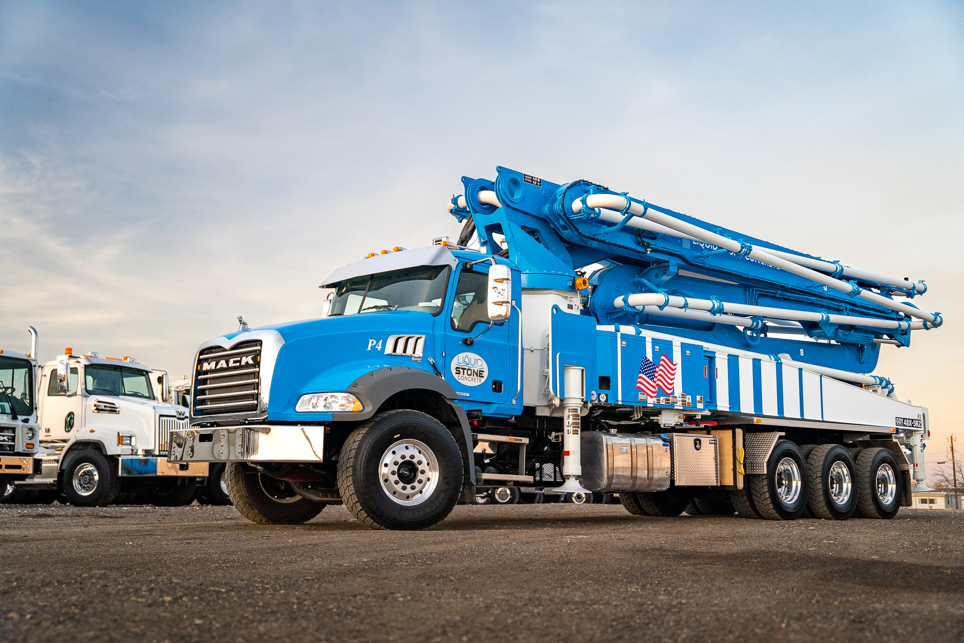 A new DY 48X-5RZ truck-mounted concrete boom pump for Liquid Concrete, photographed in the back yard of DY Concrete Pumps’ Texas headquarters.”