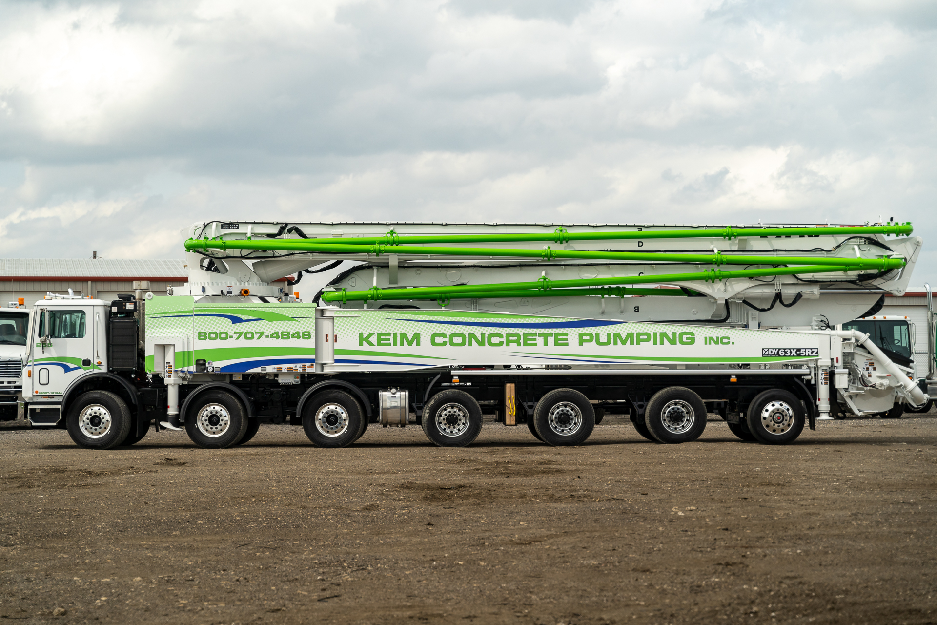 A new DY 63X-5RZ truck-mounted concrete boom pump for Keim Concrete Pumping, photographed in the back yard of DY Concrete Pumps’ Texas headquarters.
