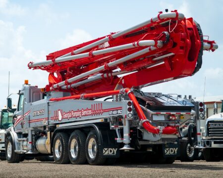 A new DY 48X-5RZ truck-mounted concrete boom pump for Georgia Pumping Services, photographed in the back yard of DY Concrete Pumps’ Texas headquarters.