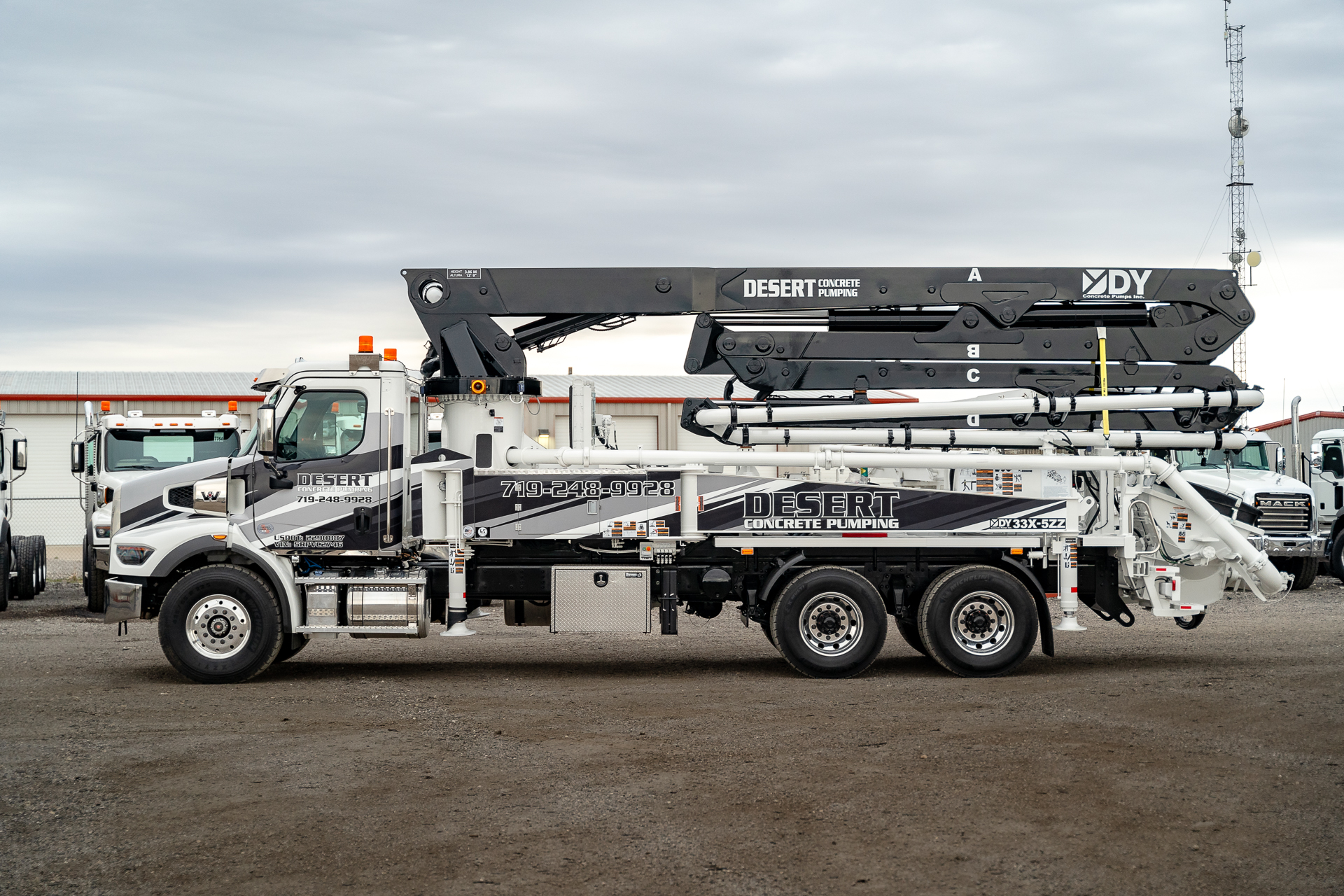 A new DY 33X-5ZZ truck-mounted concrete boom pump for Desert Concrete Pumping, photographed in the front yard of DY Concrete Pumps’ Texas headquarters.