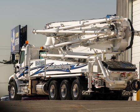 A new DY 43X-5RZ truck-mounted concrete boom pump for Hoosier Concrete Pumping, photographed in the back yard of DY Concrete Pumps’ Texas headquarters.
