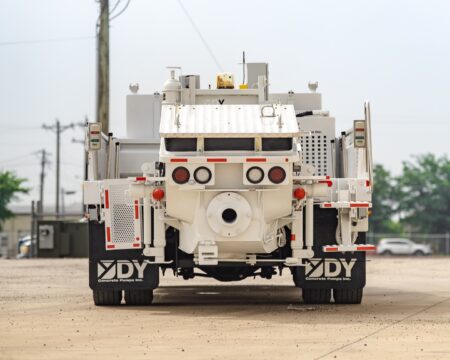 A new DY CTY-100 truck-mounted concrete line pump for Gingerich Concrete, photographed in the front yard of DY Concrete Pumps’ Texas headquarters.