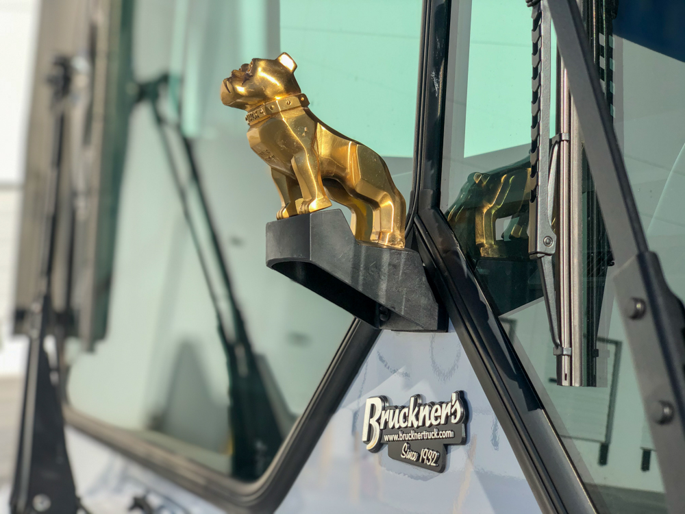 gold Mack Truck dog figurine on a DY Concrete Pumps manufactured pump