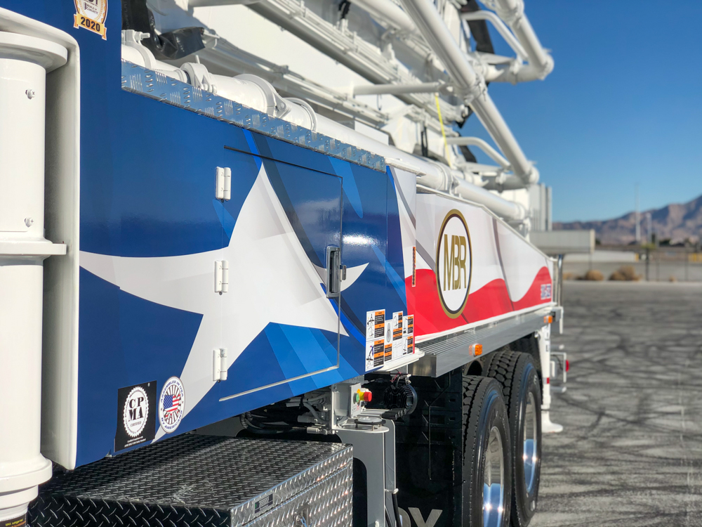 the side of a DY concrete pump showing the texas flag design and company logo
