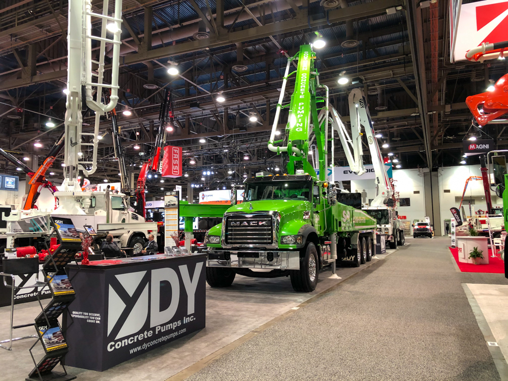 DY Concrete Pumps stand and pump trucks on display at the WOC event