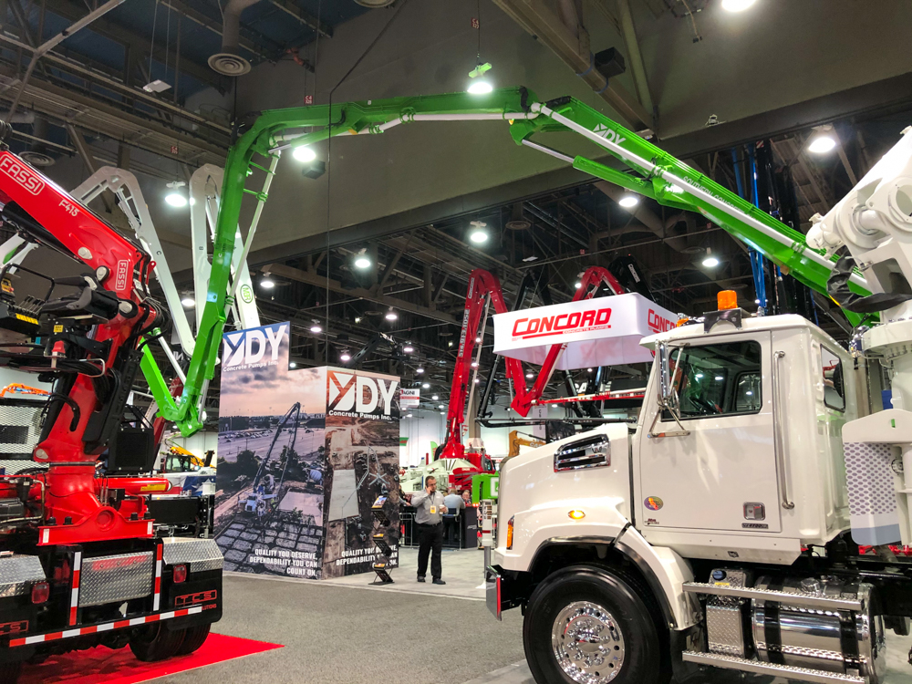 DY Concrete Pumps display and boom pump with arm extended at the WOC event