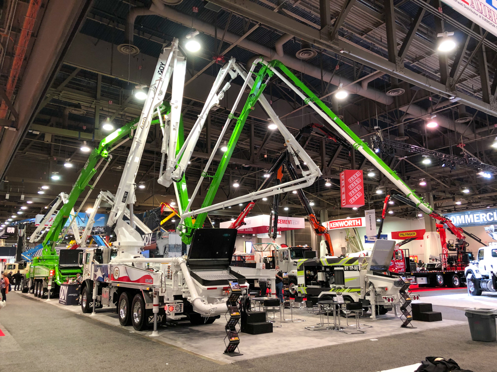 different DY concrete pumps on display inside of the World of Concrete event