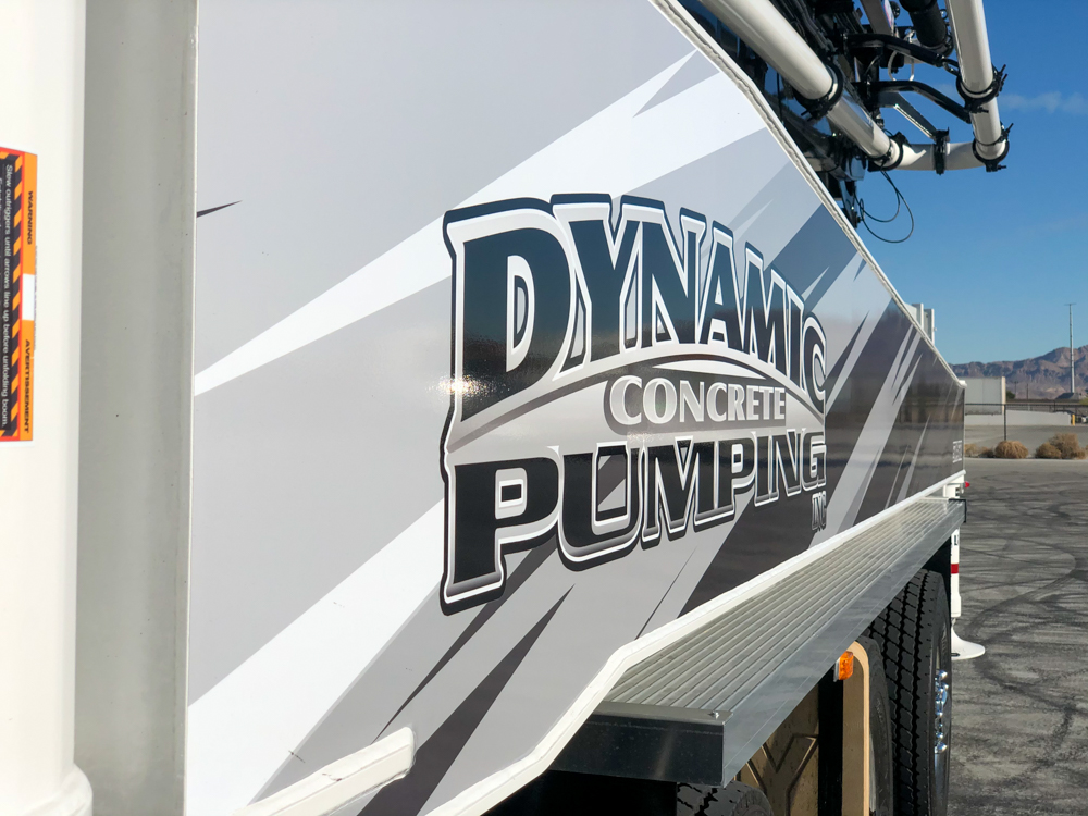 Dynamic Concrete Pumping logo on the side of the DY Concrete Pumps pump truck
